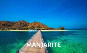 Pier leading to Manjarite Island, surrounded by clear turquoise waters in Komodo National Park.
